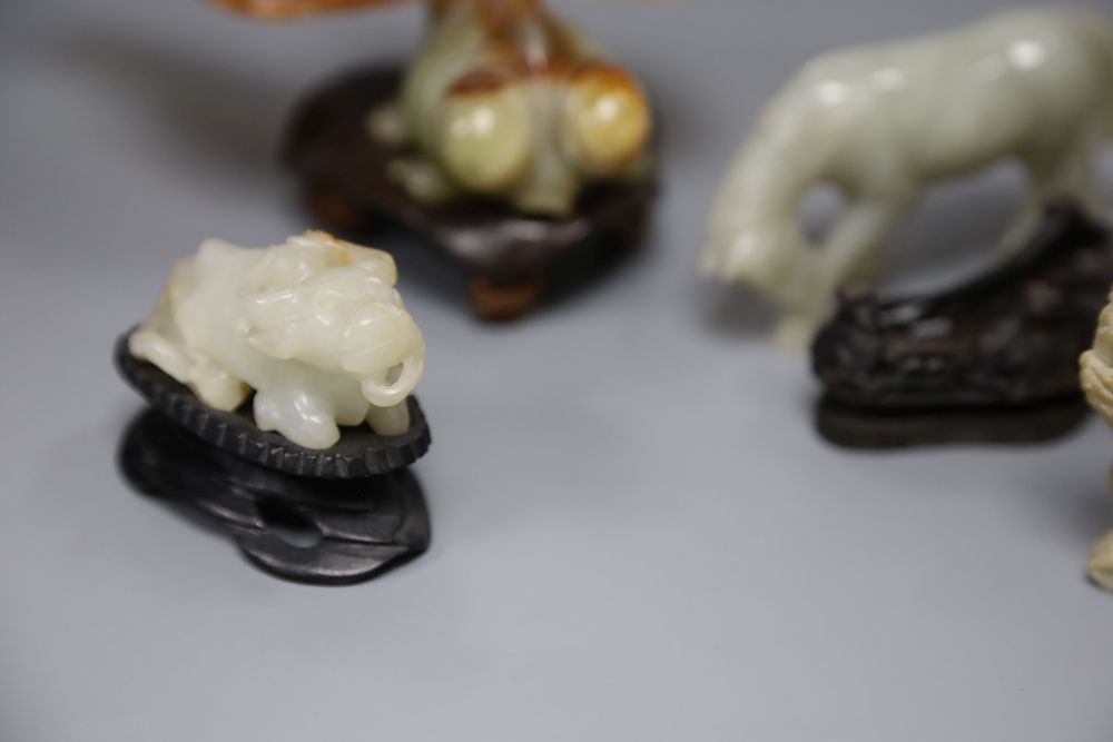 A Chinese jade figure of a buffalo, a hardstone horse and carp and a soapstone monkey